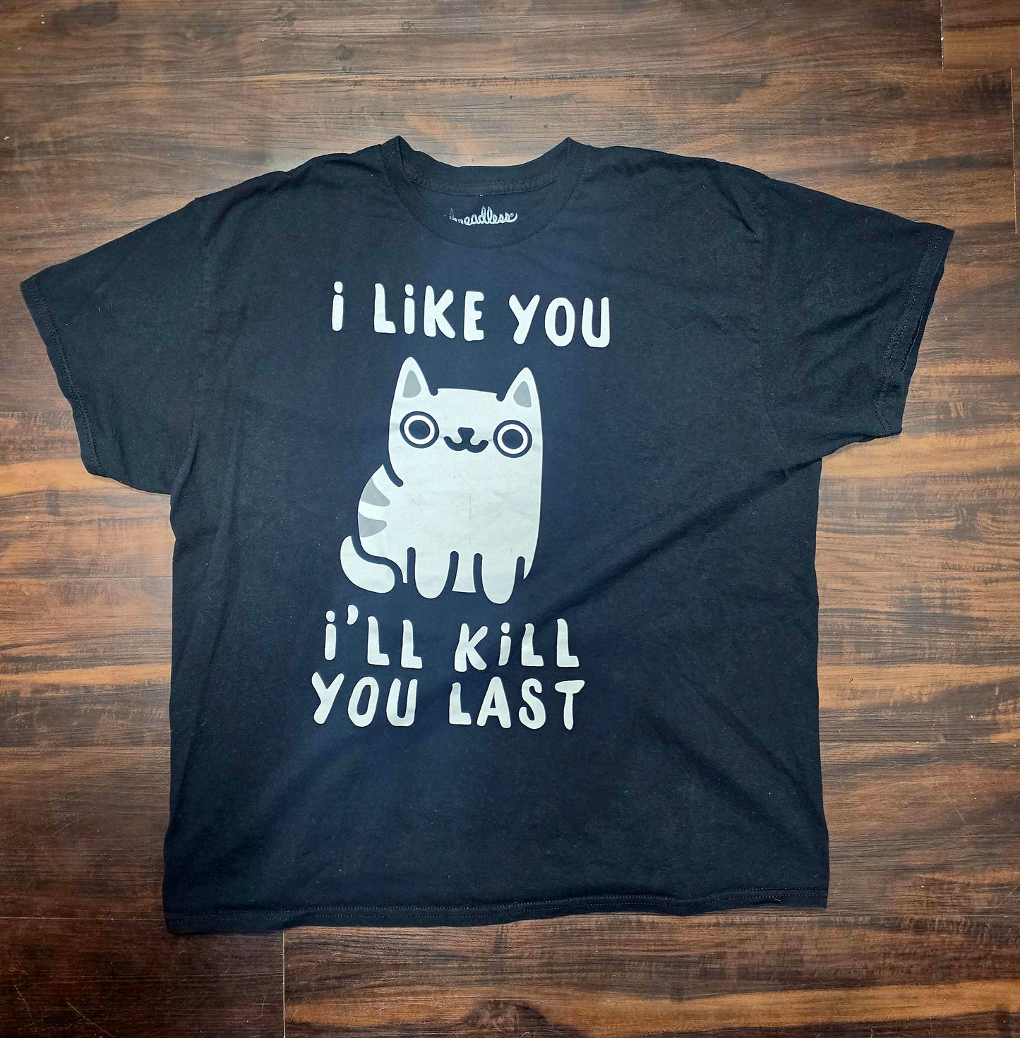 "I like you, I'll kill you last black shirt featuring a cut e little cartoon cat in the middle brand: threadless