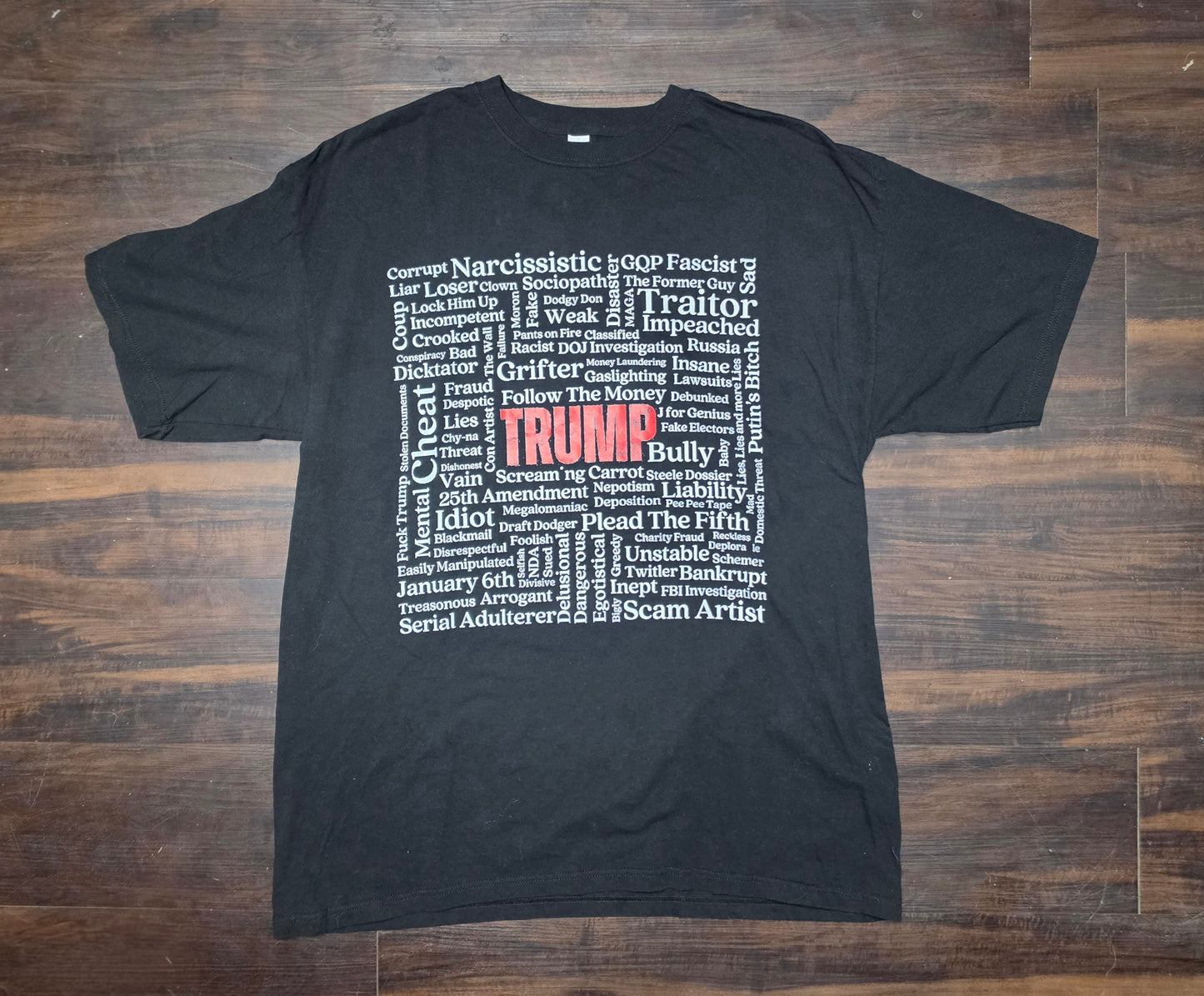 Anti- Trump black/ Tshirt Featuring Trump in big red letters with "Characteristics" written around the name in white letters