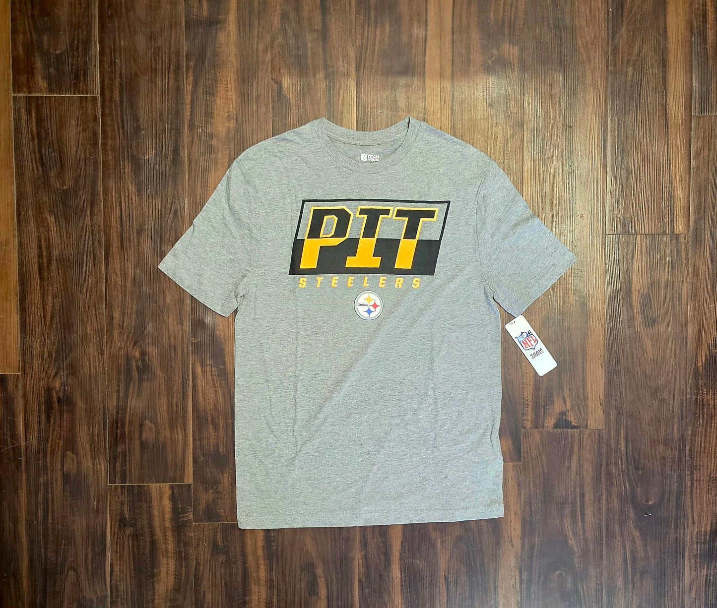 This heather gray NFL Pittsburgh Steelers t-shirt features a bold black and yellow "PIT" graphic on the chest.
